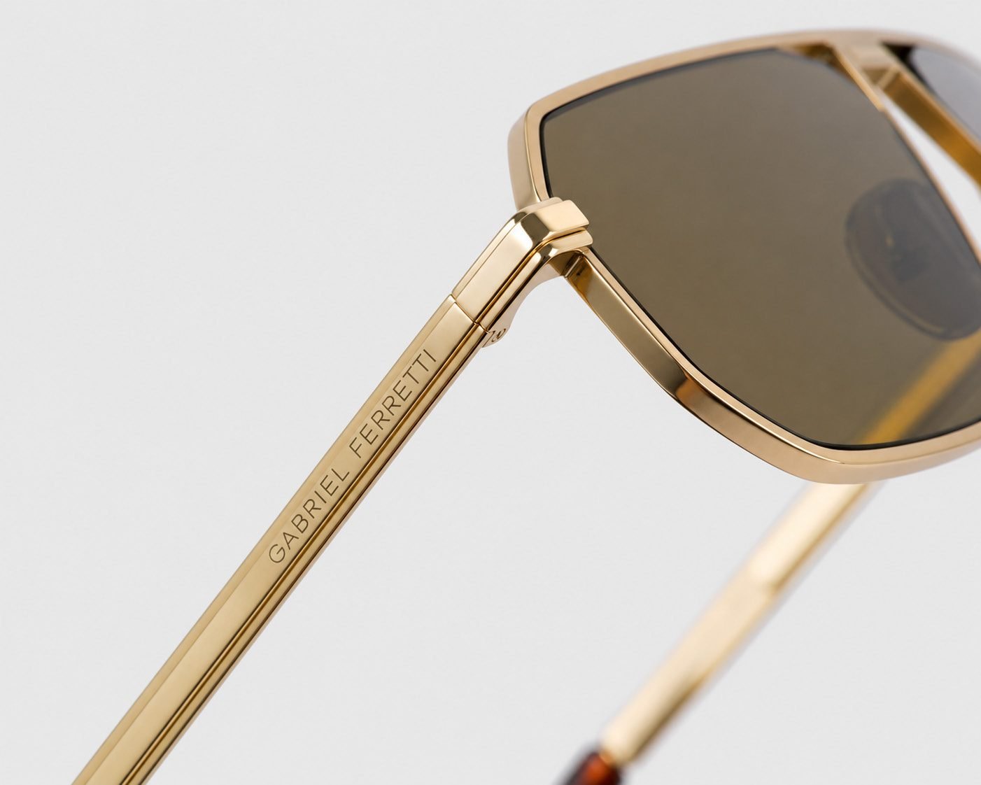 Gold-frame sunglasses with engraved temple